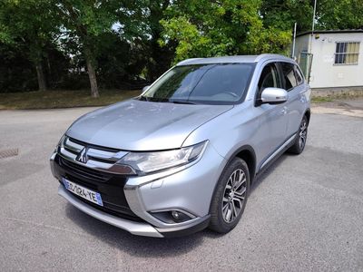 Le SUV argenté est garé sur le parking près d'une maison.