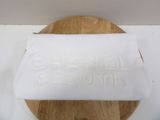 a piece of paper on a cutting board with a name on it
