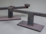 two pieces of metal that are on a white surface