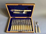 a wooden box with a set of silverware in it