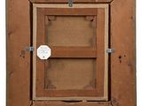 an old wooden picture frame with a tag hanging on it