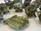 many pieces of pottery that are sitting on a table