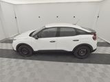 the white car is parked in the garage on the checkered floor