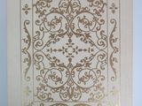 a close up of a piece of paper with a gold design on it