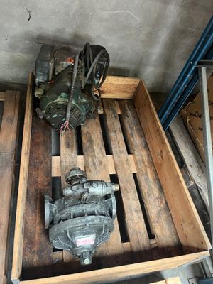 a wooden crate with a pump and other tools on it