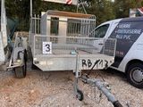 a truck with a trailer attached to it parked next to a van