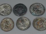 six different types of coins are shown on a white surface