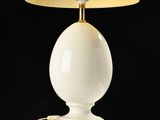 an image of a white lamp on a white table with a black background