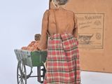 a doll that is standing next to a box