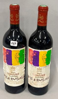 two bottles of red wine sitting next to each other on a table