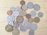 a pile of coins sitting on a wooden table