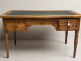 a wooden desk with two drawers and a green top