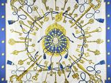 a blue and gold scarf with keys and keys on it