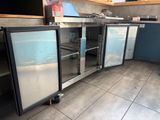 a kitchen with stainless steel cabinets and glass doors