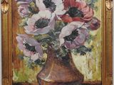 painting of anemonies in a vase on a table in a gold frame