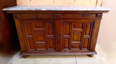 a wooden cabinet with a marble top on a tile floor