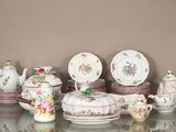 a glass table with a lot of different types of china
