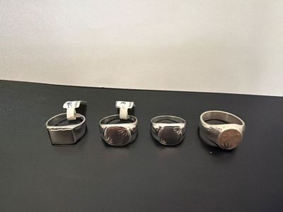 several different types of rings are displayed on a black surface