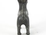 a small bronze statue of a dog on a white surface
