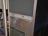 a tv on top of an ice machine in the kitchen