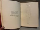 someone is holding a book with a drawing of a person in a bathing suit