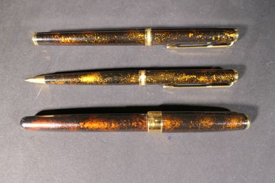 three different types of pens are lined up on a table