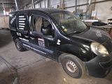 an image of a small black van in a garage