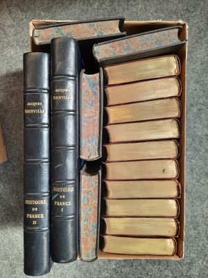 a box of books sitting on the floor next to a box of books