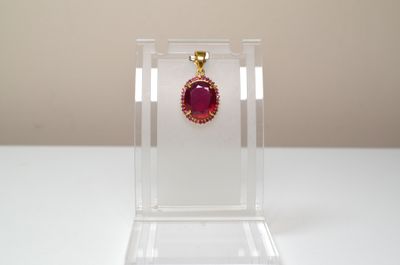 a close up of a red stone in a clear display case