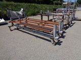 a wooden bench that is sitting in the middle of a parking lot