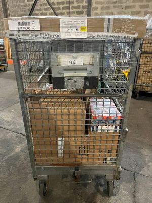 a metal cart with boxes in it in a warehouse