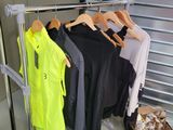 many clothes hanging on a rack in a room
