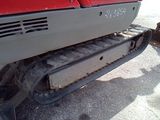 a red tractor that is parked on the side of the road