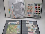 an open book with stamps on it sitting on a table