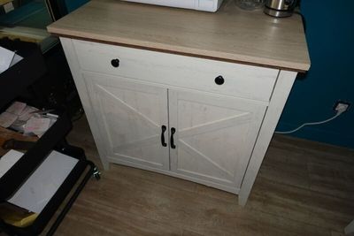 a microwave sitting on top of a cabinet in a room