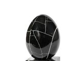 a black and white marble ball on a marble base