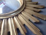 a gold sunburst that is sitting on a table