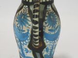 a blue and white vase sitting on a white surface