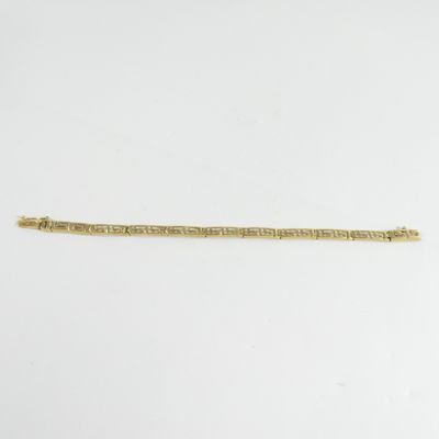 a gold bracelet with a chain that is attached to it