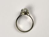 a close up of a diamond ring on a white surface