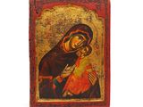 une icône représentant la Vierge Marie et l'Enfant Jésus sur un fond rouge et or