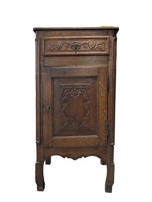 an old wooden cabinet with a door and a drawer on top of it