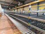 many shelves that are lined up in the warehouse
