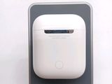 a white airpods sitting on top of a gray surface