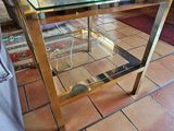 a glass table with a vase on it in a living room