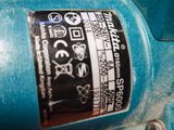 a close up of a blue machine with a sticker on it