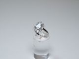 a diamond ring sitting on top of a glass of water