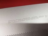 an image of a close up of a silver speaker on a red surface