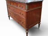 an antique chest of drawers with marble top