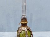 a glass vase with a green apple inside of it